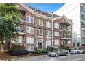 Traditional brick building with black iron balconies and decorative trim located on a tree-lined street at 61 16Th Ne St # 4, Atlanta, GA 30309