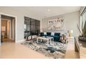 Stylish living room showcases a teal sofa, modern artwork, chic furnishings and light hardwood flooring at 775 Juniper Ne St # 612, Atlanta, GA 30308