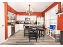 Bright kitchen featuring stainless steel appliances, hardwood flooring and a decorative chandelier at 9155 Nesbit Ferry Rd, Alpharetta, GA 30022