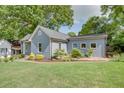 Beautifully landscaped backyard with lush green grass, garden beds, and mature trees create a serene outdoor space at 1143 Church Nw St, Atlanta, GA 30318