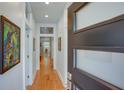 Bright hallway with hardwood floors, white walls, and a front door with modern glass panes, creating an open, airy feel at 1143 Church Nw St, Atlanta, GA 30318