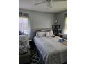 Cozy bedroom with a neutral palette, featuring a comfortable bed, soft lighting, and a ceiling fan at 1990 Shamrock Dr, Decatur, GA 30032