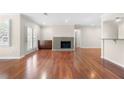 Bright living room featuring a fireplace, hardwood floors, and access to a balcony through french doors at 1538 Chantilly Ne Dr # 224, Atlanta, GA 30324
