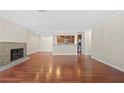 Spacious living room with hardwood floors, a fireplace, and an open view of the modern kitchen at 1538 Chantilly Ne Dr # 224, Atlanta, GA 30324