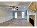 Bright living room with a brick fireplace, neutral paint, and plush carpet at 4397 Windsor Oaks Cir, Marietta, GA 30066