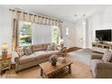 Bright living room featuring a large window, comfortable seating, and a cozy rug at 4865 Fenbrook Dr, Stone Mountain, GA 30088