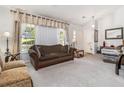 Inviting living room featuring a comfortable sofa, neutral carpet, and bright natural light, creating a welcoming atmosphere at 4865 Fenbrook Dr, Stone Mountain, GA 30088