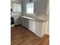Well-lit kitchen space with standard appliances, white cabinets and countertops, offering functionality at 783 Fox Valley Dr, Stone Mountain, GA 30088