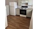 Functional kitchen with white cabinets, black gas range, and a standard white refrigerator at 783 Fox Valley Dr, Stone Mountain, GA 30088
