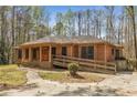 Beautiful brick home with a ramp, front porch, and tasteful landscaping in a serene setting at 100 Hall Pl, Fayetteville, GA 30215