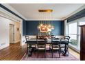 Dining room featuring navy walls, modern lighting, and a large window at 285 Lackland Court, Sandy Springs, GA 30350