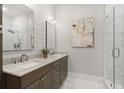Modern bathroom features double sinks, marble countertops, neutral colors, and a glass shower at 8240 Sonata Ln, Cumming, GA 30041