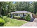 Well-maintained home with lush lawn, complemented by mature trees and a private driveway at 184 Rambo Sw Pl, Marietta, GA 30064