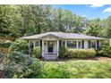 Inviting home featuring a manicured lawn and charming front facade surrounded by lush greenery at 184 Rambo Sw Pl, Marietta, GA 30064