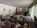 View of cluttered living room with white walls and curtains ready for a new design vision at 185 W Lake Nw Dr, Atlanta, GA 30314