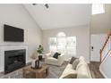 Bright living room with vaulted ceilings, a cozy fireplace, and large windows at 2447 Stancrest Ln, Lawrenceville, GA 30044