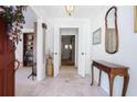 Inviting entryway showcases a tiled floor, white walls, and an elegant table with a mirror above it at 5170 Oxbow Rd, Stone Mountain, GA 30087