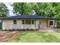 Charming single-story home featuring a freshly manicured lawn and classic light brick facade at 2131 Glendale Dr, Decatur, GA 30032