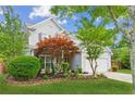 Charming two-story home boasts lush landscaping, an attached two-car garage, and mature trees at 2173 Beacon Crest Dr, Buford, GA 30519