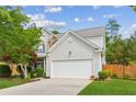 Charming two-story home boasts lush landscaping, an attached two-car garage, and mature trees at 2173 Beacon Crest Dr, Buford, GA 30519