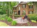 A beautiful landscaped front yard with a fountain and a bench create a welcoming outdoor space at 230 Leaf Court, Alpharetta, GA 30005