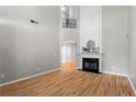 Bright living room with a cozy fireplace, hardwood floors, and soaring ceilings at 4910 Longcourt Se Trce # 13, Atlanta, GA 30339