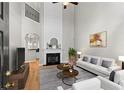 Spacious living room with high ceilings, fireplace, hardwood floors, and lots of natural light at 4910 Longcourt Se Trce # 13, Atlanta, GA 30339