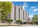 High-rise condo building with balconies, showcasing city living with mature trees, and elegant design at 1130 Piedmont Ne Ave # 803, Atlanta, GA 30309
