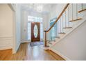 Inviting foyer with hardwood floors, a wooden staircase, and a decorative front door, creating a warm welcome at 2695 Rangewood Ne Dr, Atlanta, GA 30345