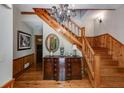 Inviting foyer with hardwood floors, stairs, a chandelier, and decorative woodwork adding classic charm at 7720 Milam Rd, Winston, GA 30187