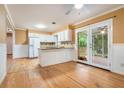 Bright kitchen with white cabinets, granite countertops, and access to the screened porch at 890 Oriole Se Ln, Marietta, GA 30067