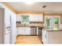 Bright kitchen featuring white cabinets, stainless steel appliances, and granite countertops at 890 Oriole Se Ln, Marietta, GA 30067