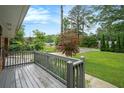 Inviting porch with grey railing offers serene views of the lush front yard at 890 Oriole Se Ln, Marietta, GA 30067