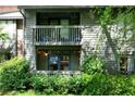 Two-story condo with brick accents and a covered balcony overlooking lush landscaping at 1205 Mcclelen Way, Decatur, GA 30033