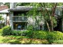 Two-story condo with brick accents and a covered balcony surrounded by lush landscaping at 1205 Mcclelen Way, Decatur, GA 30033