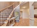 Bright foyer featuring hardwood floors, staircase with iron spindles and natural light at 149 Stargrass Way, Grayson, GA 30017