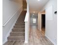 Inviting hallway with a staircase and wood-look floors at 2272 Gateway Trl, Ellenwood, GA 30294