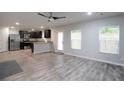 Open-concept living area with stainless steel appliances, lots of light and wood-look floors at 2272 Gateway Trl, Ellenwood, GA 30294