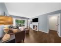 Living room featuring a fireplace, hardwood floors and a balcony with wooded views at 25305 Plantation Ne Dr, Atlanta, GA 30324