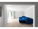 Spacious living area showcasing a blue sofa and large windows, offering ample natural light at 3075 Milford Sw, Marietta, GA 30008