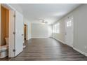 Spacious living room with new hardwood floors, fan and neutral paint colors at 3920 Stonewall Tell Rd, Atlanta, GA 30349