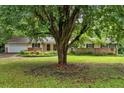 Traditional ranch home with brick accents, a well-kept lawn, and mature trees providing shade at 450 S Susan Creek Dr, Stone Mountain, GA 30083
