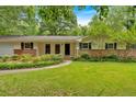 Well-maintained ranch-style home featuring a brick facade and a spacious, green front yard at 450 S Susan Creek Dr, Stone Mountain, GA 30083