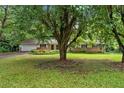Ranch-style home with a brick and siding exterior, surrounded by mature trees and a lush green lawn at 450 S Susan Creek Dr, Stone Mountain, GA 30083