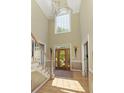 Bright foyer featuring hardwood floors, staircase, high ceilings, and a transom window above the front door at 935 Brookline Way, Alpharetta, GA 30022