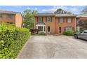 Charming brick townhome with black shutters and a well-manicured front yard at 1995 Raleigh Tavern Dr, Roswell, GA 30076