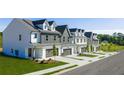 New townhomes with gray and white exteriors, two-car garages, and landscaped front yards offer modern living at 210 Sharon Ln, Loganville, GA 30052
