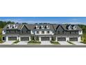 Newly built townhomes with modern exteriors, garages, and well-maintained landscaping, offering curb appeal at 210 Sharon Ln, Loganville, GA 30052