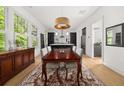 Elegant dining room with hardwood floors, modern light fixture and view into the gourmet kitchen at 262 Southerland Ne Ter, Atlanta, GA 30307