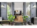Grand entryway into an open-concept home, featuring a charming bench and potted plants enhancing the inviting atmosphere at 262 Southerland Ne Ter, Atlanta, GA 30307